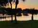 Scenic water view at sunset with trees and reflections in the water at 3600 105Th N Ave, Clearwater, FL 33762