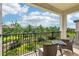 Relaxing balcony with outdoor seating and views of the lush, green neighborhood at 5095 San Martino Dr, Wesley Chapel, FL 33543