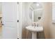 Powder bathroom featuring a pedestal sink, oval mirror, and modern faucet at 5095 San Martino Dr, Wesley Chapel, FL 33543