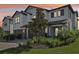 Exterior view of a townhome with a well-manicured lawn and a brick driveway at 5095 San Martino Dr, Wesley Chapel, FL 33543