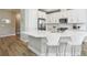 Modern kitchen featuring white cabinetry, stainless steel appliances, a subway tile backsplash, and a quartz countertop island at 5095 San Martino Dr, Wesley Chapel, FL 33543