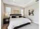 Elegant main bedroom features recessed lighting, contemporary artwork, and a plush king-size bed at 5095 San Martino Dr, Wesley Chapel, FL 33543