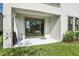 Covered patio with sliding glass doors leading to a grassy backyard at 5095 San Martino Dr, Wesley Chapel, FL 33543