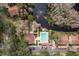 Aerial view of a community featuring a pool, pond with fountain, clubhouse, and tennis court at 515 Mistletoe Ct # C, Safety Harbor, FL 34695