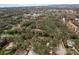 An aerial view captures a residential area dotted with trees, homes, and glimpses of a distant body of water at 515 Mistletoe Ct # C, Safety Harbor, FL 34695