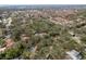 An aerial view showcases a residential area with houses, trees, and a glimpse of a distant ocean at 515 Mistletoe Ct # C, Safety Harbor, FL 34695