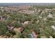 A high aerial shows condos surrounded by lush trees in a neighborhood with lake views at 515 Mistletoe Ct # C, Safety Harbor, FL 34695