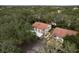 An aerial view showcases the apartment buildings surrounded by lush trees at 515 Mistletoe Ct # C, Safety Harbor, FL 34695