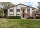 This condo has a traditional facade with a screened porch and staircase leading to the upper levels at 515 Mistletoe Ct # C, Safety Harbor, FL 34695