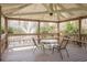 The gazebo features a table and seating, offering a peaceful view of the fountain and lake at 515 Mistletoe Ct # C, Safety Harbor, FL 34695