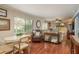 Cozy living area with wood floors, large windows, and sliding glass doors to the screened porch, creating a warm and inviting space at 515 Mistletoe Ct # C, Safety Harbor, FL 34695