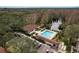 An aerial view of a community pool and recreation area featuring a fountain, seating, and parking at 515 Mistletoe Ct # C, Safety Harbor, FL 34695