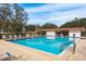 Community pool with lounge chairs and clear blue water on a bright, sunny day at 515 Mistletoe Ct # C, Safety Harbor, FL 34695