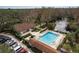 Overhead view of a community pool area with a lake, fountain, clubhouse, and parking at 515 Mistletoe Ct # C, Safety Harbor, FL 34695