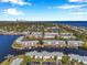 Expansive aerial view of condo community with canal access and distant city skyline at 5152 Salmon Se Dr # C, St Petersburg, FL 33705