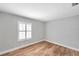 Bright bedroom featuring wood-look floors, a window with white shutters, and neutral walls at 5152 Salmon Se Dr # C, St Petersburg, FL 33705