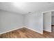 Bedroom with wood-look floors, neutral walls, and an open doorway at 5152 Salmon Se Dr # C, St Petersburg, FL 33705