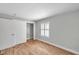 Bedroom with wood-look floors, neutral walls, window with white shutters, and closet at 5152 Salmon Se Dr # C, St Petersburg, FL 33705