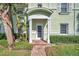 Charming condo entrance with brick pathway, lush landscaping, and covered doorway at 5152 Salmon Se Dr # C, St Petersburg, FL 33705