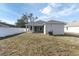 View of backyard features a white fence, patio, and neutral exterior at 5341 71St N Way, St Petersburg, FL 33709