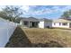 The backyard features a white vinyl fence and access to the covered patio at 5341 71St N Way, St Petersburg, FL 33709