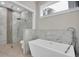 Luxurious bathroom featuring a freestanding tub and a glass-enclosed shower at 5341 71St N Way, St Petersburg, FL 33709