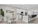 Bright kitchen and dining area featuring stainless steel appliances, white cabinetry, and stylish furnishings at 5341 71St N Way, St Petersburg, FL 33709