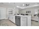 A modern kitchen with a center island, stainless steel appliances, and tile flooring at 5341 71St N Way, St Petersburg, FL 33709