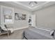 Well-lit bedroom with neutral walls, modern furniture, and an open doorway to living area at 5341 71St N Way, St Petersburg, FL 33709