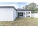 A rear exterior of the home featuring a covered patio and fenced backyard at 5351 71St N Way, St Petersburg, FL 33709