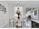 Bright dining area with modern chandelier, round table, and view of the outdoor patio at 5351 71St N Way, St Petersburg, FL 33709