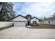 This home features a two-car garage, concrete driveway and a quaint facade at 5351 71St N Way, St Petersburg, FL 33709