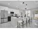 A modern, all-white kitchen with quartz countertops and stainless steel appliances at 5351 71St N Way, St Petersburg, FL 33709