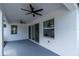 Covered patio with ceiling fans and sliding glass doors offering a relaxing outdoor space at 5351 71St N Way, St Petersburg, FL 33709