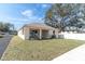 Spacious backyard includes a lawn area, a covered patio and a white privacy fence at 5361 71St N Way, St Petersburg, FL 33709