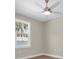 Bright bedroom features a modern ceiling fan, hardwood floors, and a window with a pleasant outdoor view at 5361 71St N Way, St Petersburg, FL 33709