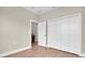 Bedroom features a double door closet, door to another room, neutral walls, and wood laminate flooring at 5361 71St N Way, St Petersburg, FL 33709