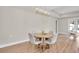 Bright dining area with wood floors, contemporary light fixture and a round table with seating for four at 5361 71St N Way, St Petersburg, FL 33709