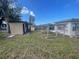 Expansive backyard with a shed, wooden structures, and lush green grass at 540 Florida S Cir, Apollo Beach, FL 33572