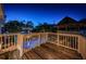 Spacious wooden deck overlooks the pool and lush tropical landscaping, with a view towards the beach at 614 Maryland Ave, Crystal Beach, FL 34681