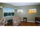 Bedroom with matching floral chairs, light-green walls, and sunset views at 614 Maryland Ave, Crystal Beach, FL 34681