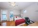 Well-lit bedroom with hardwood flooring, natural light, and a modern desk at 614 Maryland Ave, Crystal Beach, FL 34681