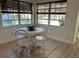 Cozy breakfast nook with white wood table and chairs and views of the pool at 614 Maryland Ave, Crystal Beach, FL 34681