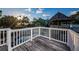 Wooden deck featuring a gazebo with view of swimming pool and palm trees at 614 Maryland Ave, Crystal Beach, FL 34681