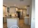 Well-lit kitchen with stainless steel appliances, white cabinets, and island counter seating at 614 Maryland Ave, Crystal Beach, FL 34681