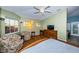 Large bedroom with vaulted ceilings, lots of light, ceiling fan, and seating area at 614 Maryland Ave, Crystal Beach, FL 34681