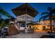 An outdoor bar with seating is underneath a covered tiki hut, steps to the second-story deck at 614 Maryland Ave, Crystal Beach, FL 34681