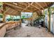 The outdoor bar area features wood countertops, barstools, and a grill for entertaining at 614 Maryland Ave, Crystal Beach, FL 34681