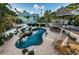 An inviting backyard oasis with a sparkling pool, hot tub, tiki bar, and ample space for outdoor gatherings at 614 Maryland Ave, Crystal Beach, FL 34681