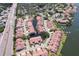 An aerial view of a large community with mature trees, landscaping, and a winding canal at 6328 Newtown Cir # 28A1, Tampa, FL 33615